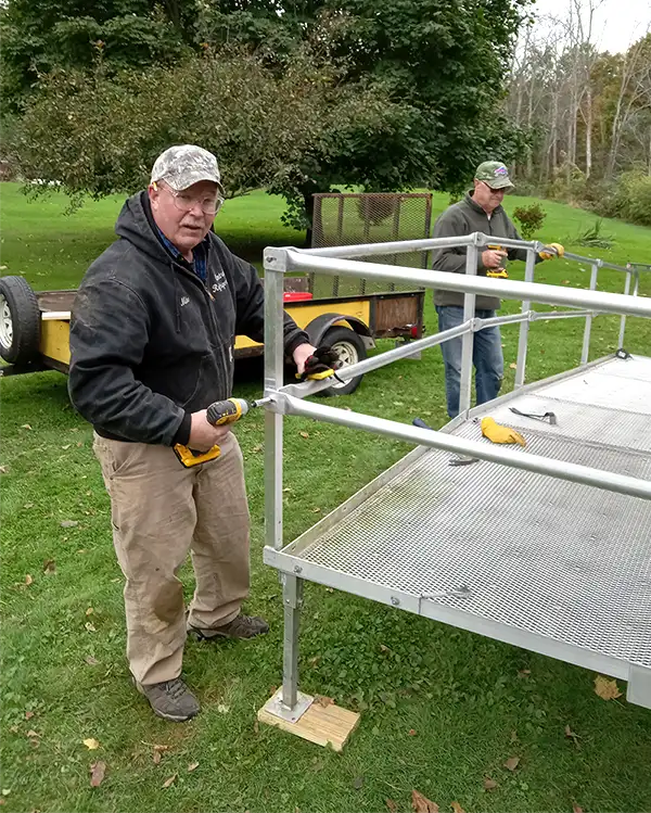 volunteers assembling a wheelchair ramp